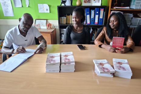 Antony Wesonga signing the visitors book