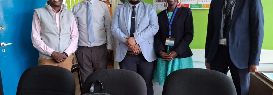 Mayotte university president with pose for a photo with staff from literature 